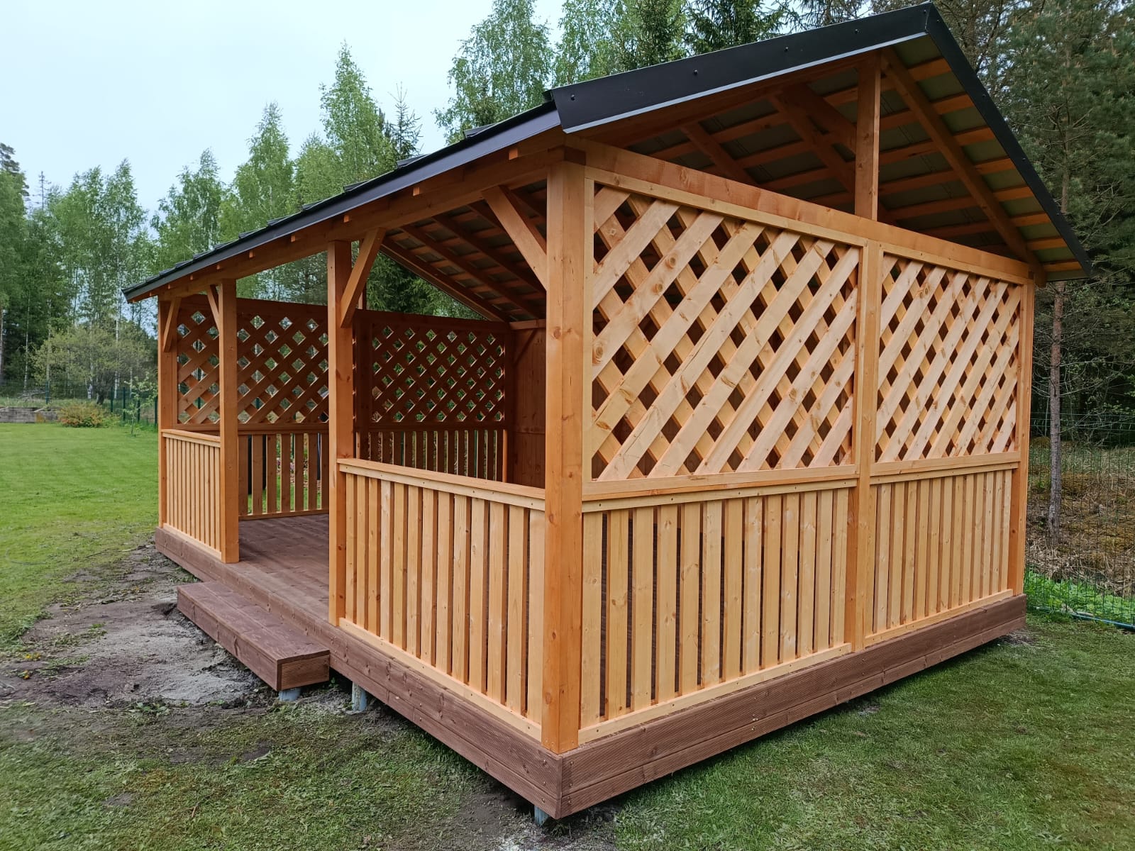 Lapene 4x6 m ar brūnu koka grīdu un pakāpienu – stūra skats
